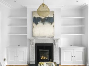 Alcove fitted TV cabinets with bookshelves.