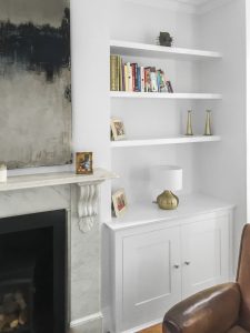 Alcove fitted TV cabinets with bookshelves.