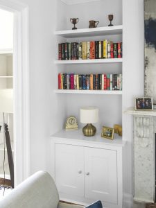 Alcove fitted TV cabinets with bookshelves.