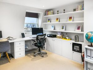Office room fitted with our cabinets, desk and floating shelves