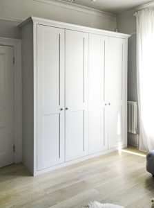 Shaker style fitted living room wardrobe, painted white eggshell.