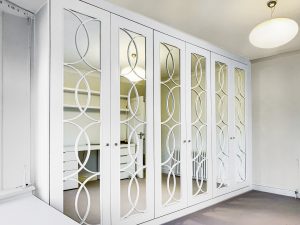 A huge 4 metres long wardrobe with mirrored doors with and nice fretwork