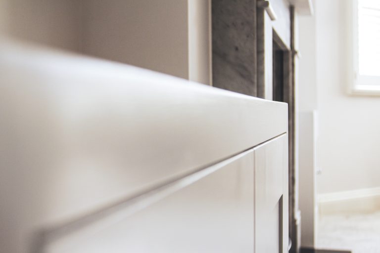 Alcove fitted TV cabinets with bookshelves besides the chimney