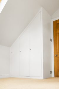 Contemporary MDF sloping wardrobe fitted in the loft spare room.