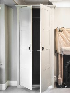 Alcove fitted wardrobes with Walnut veneer MDF inside and painted doors