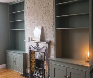 Two traditional style bookcases beside the chimney breast