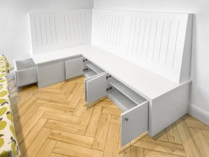 Fitted L-shape bench. A nice mixture of sitting space, drawer and storage with doors and shelving. One of the best solutions for a dining room.