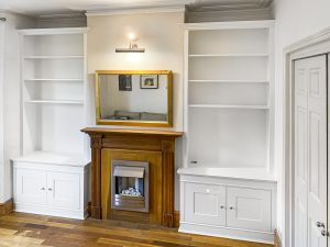 Two traditional style bookcases beside the chimney breast